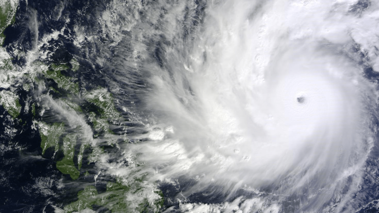 Urban heat impacts and friction in a tropical cyclone